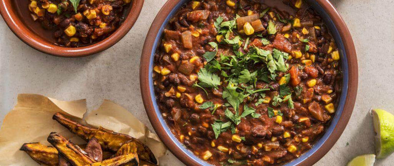 Vegetarian chili with sweet potato wedges and guac